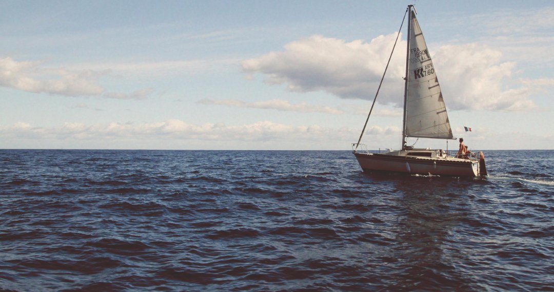 A sailboat gliding across the ocean