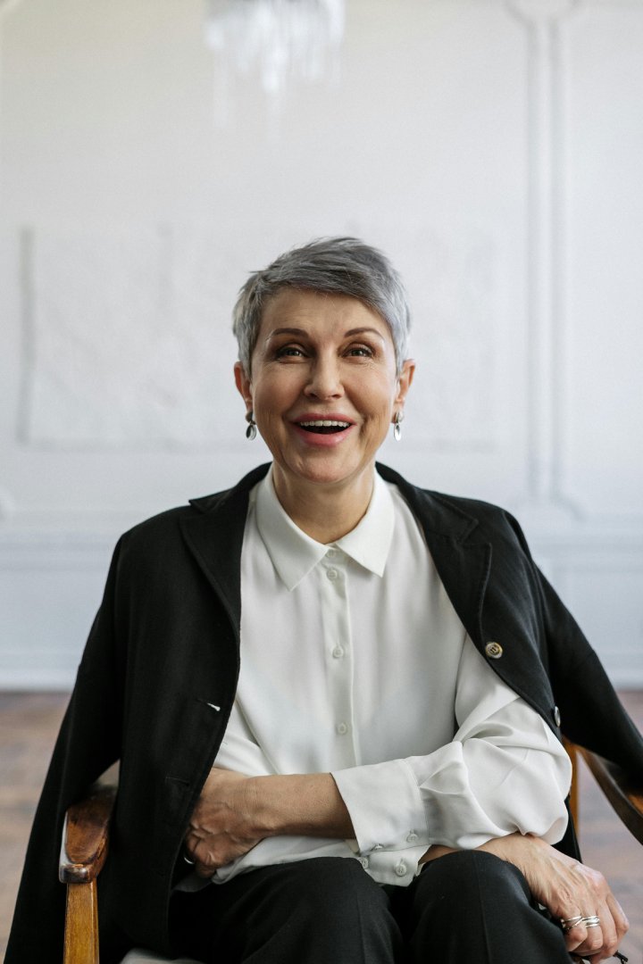 Portrait of a mature woman sitting gracefully in a chair