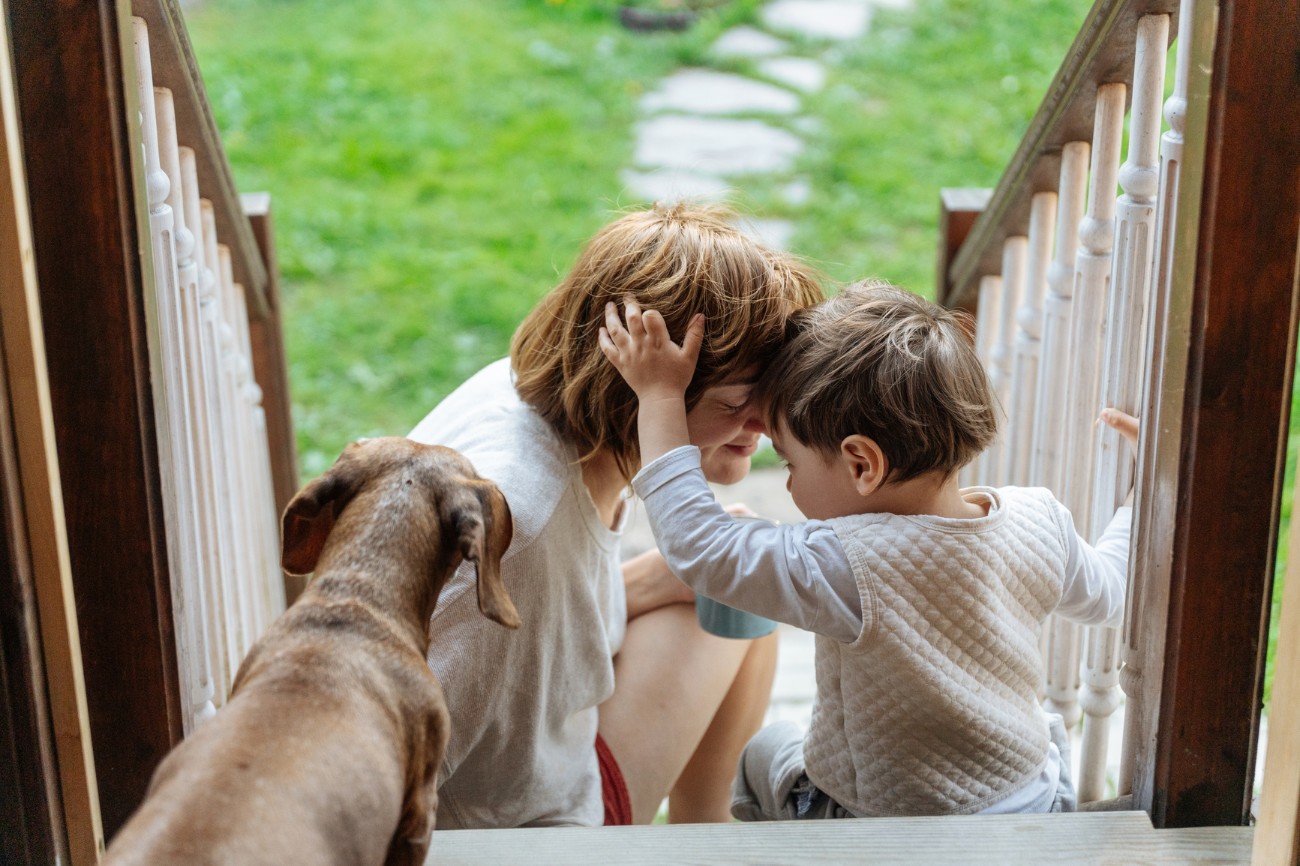 mom and young son sitting on front steps